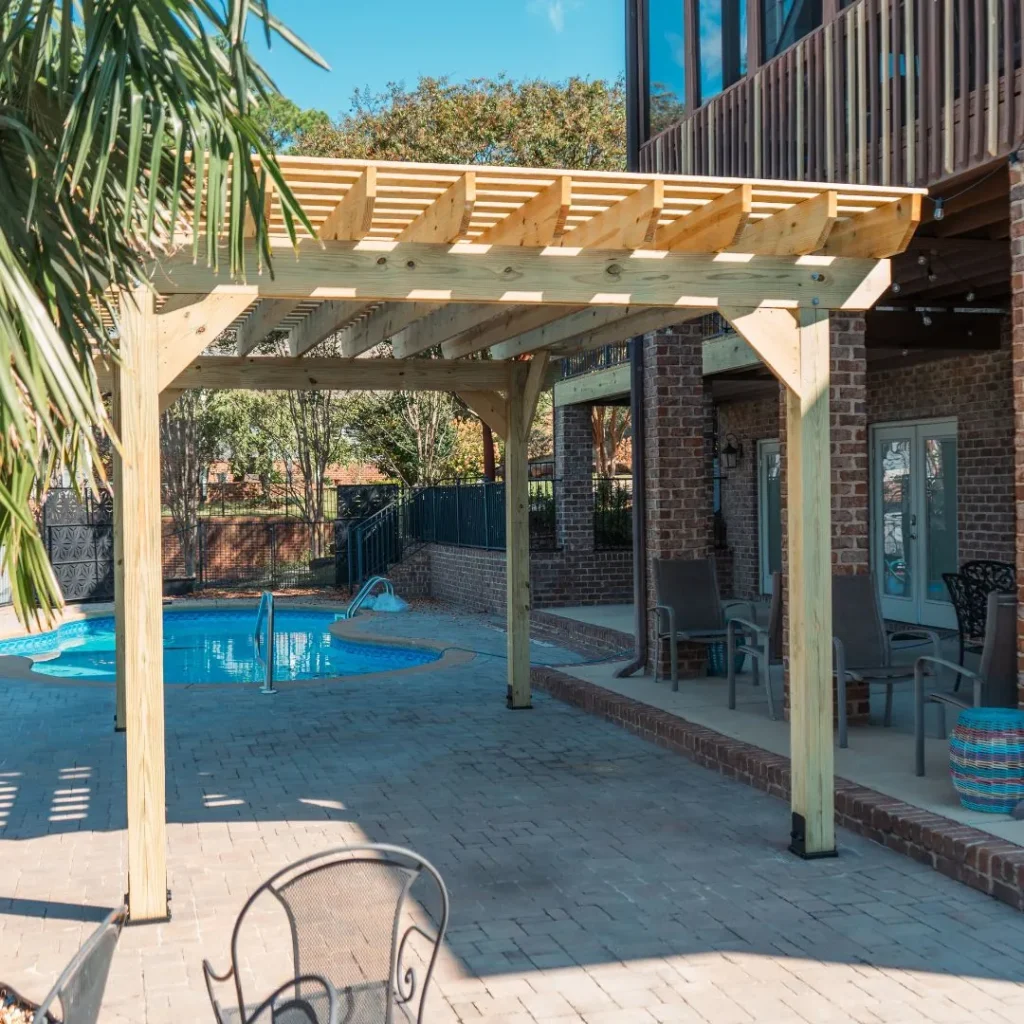 a new pergola next to a swimming poo