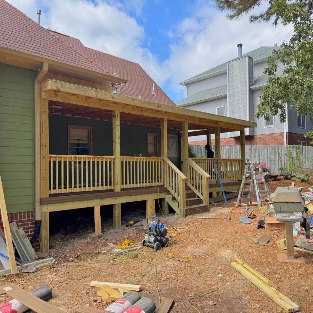 a porch with new railing and columns